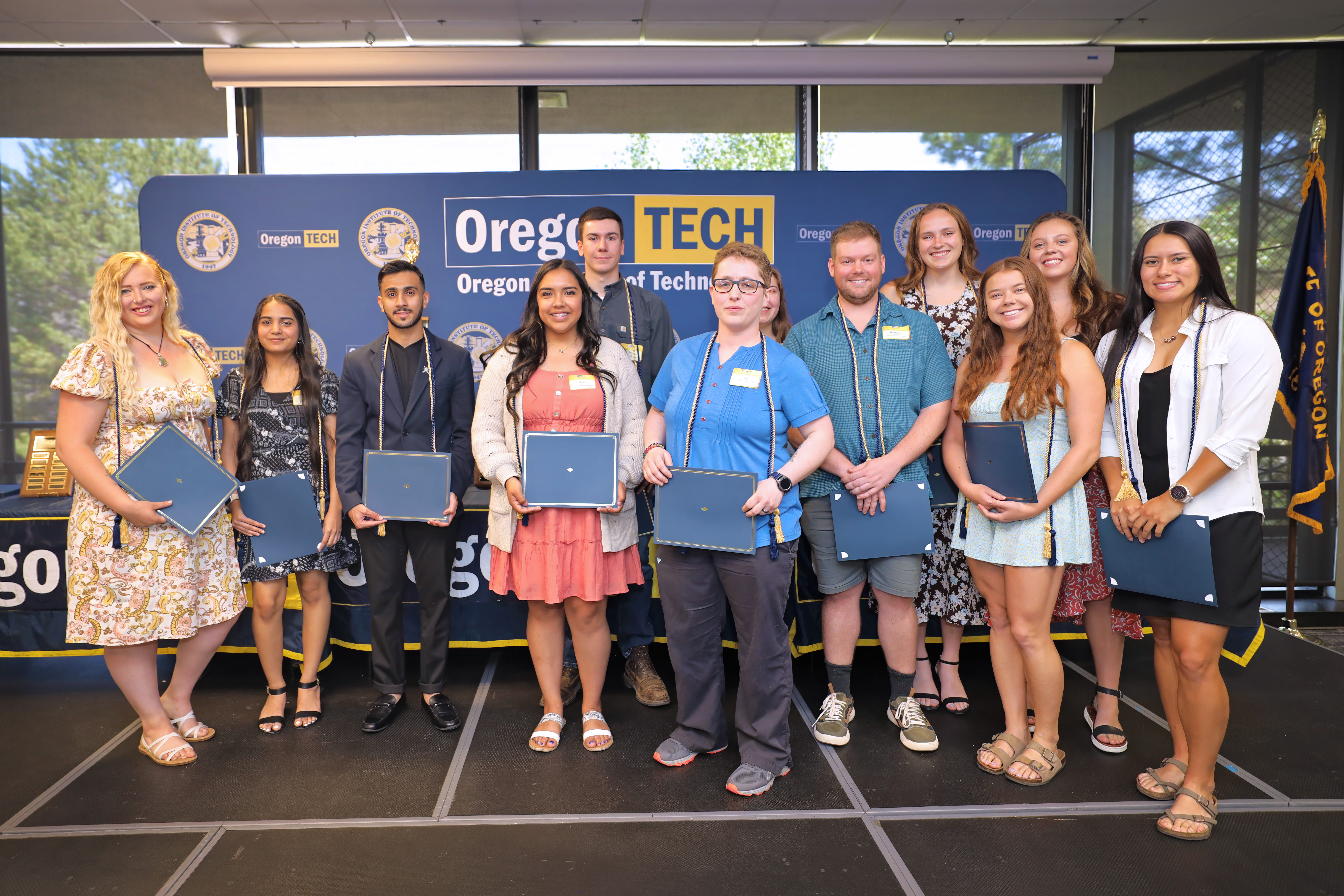 A photo at the 2024 Student and Alumni Awards event with the recipients on stage. 